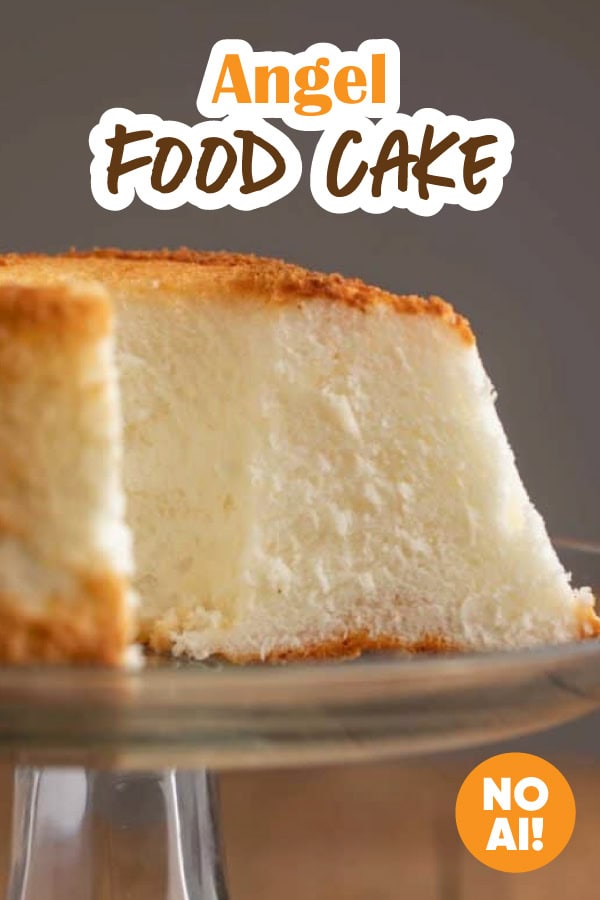 Large fluffy angel food cake showing a tall slice.