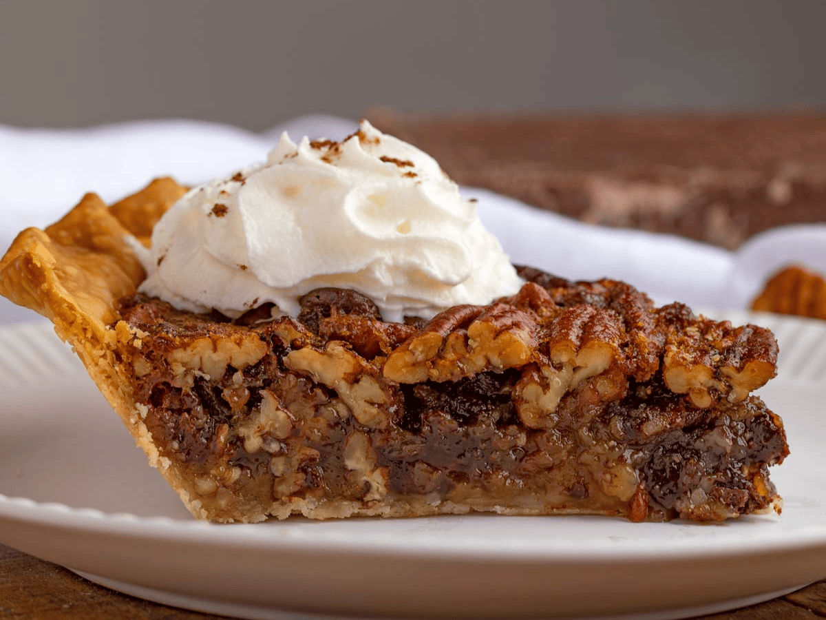 Closeup of slice of dessert with whipped cream on top