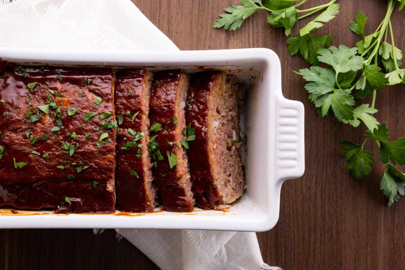 Classic Beef Meatloaf sliced in loaf pan