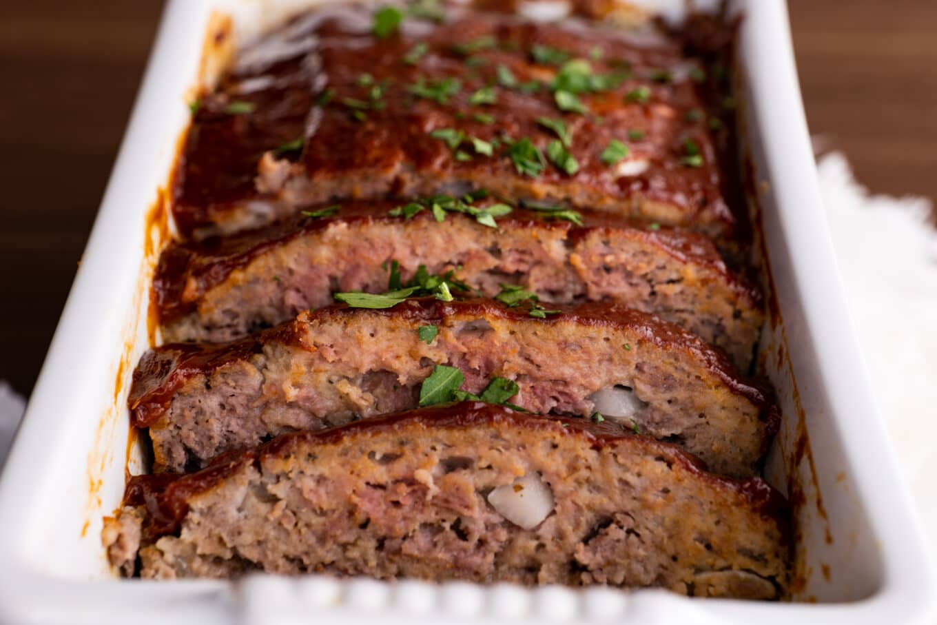 Classic Beef Meatloaf sliced in loaf pan