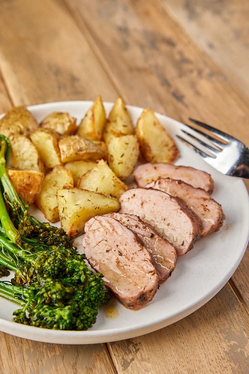 Grilled Pork Tenderloin sliced on plate with potatoes and broccoli