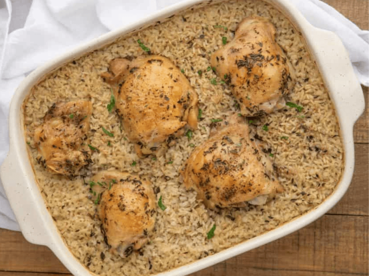 Chicken on top of rice in baking dish