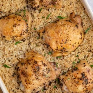 Baked Chicken and Rice in a white Casserole dish