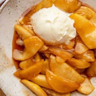 Fried Apples in a bowl with ice cream.