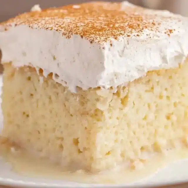 slice of cake with whipped cream and cinnamon on top