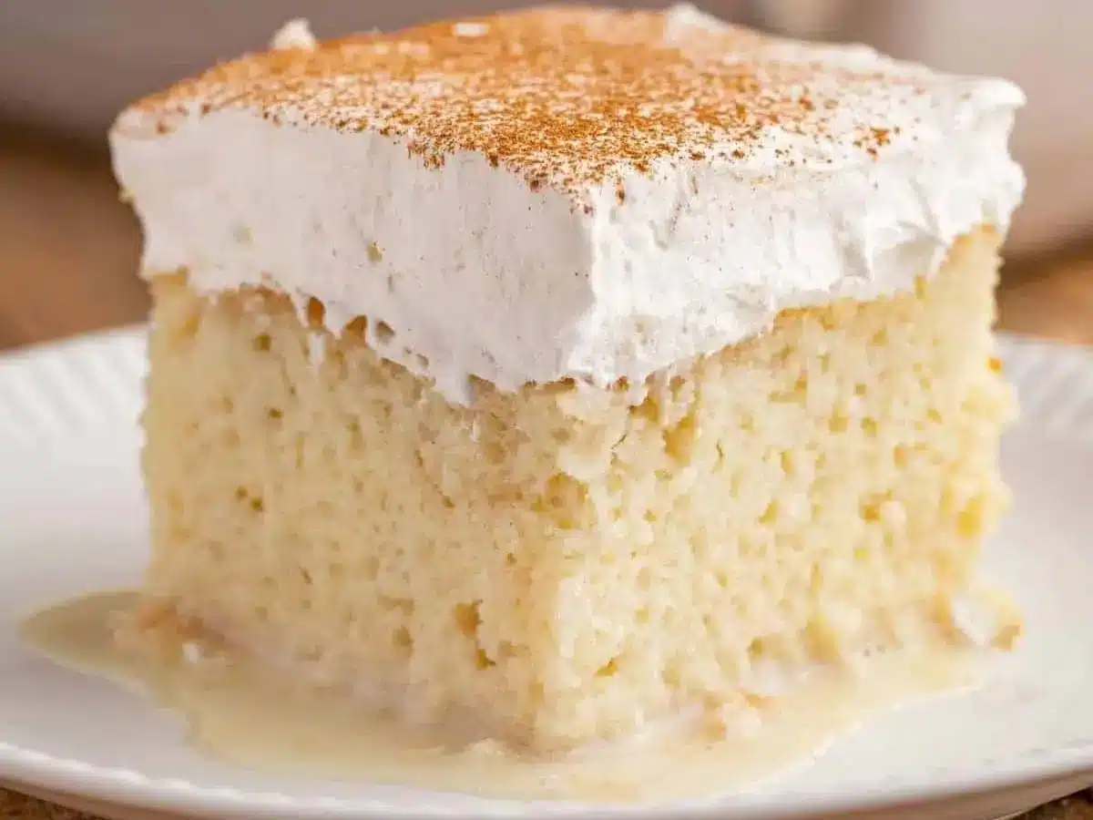 slice of cake with whipped cream and cinnamon on top