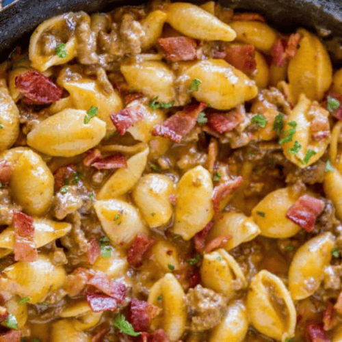 beef and noodle mixture cooking in cast iron