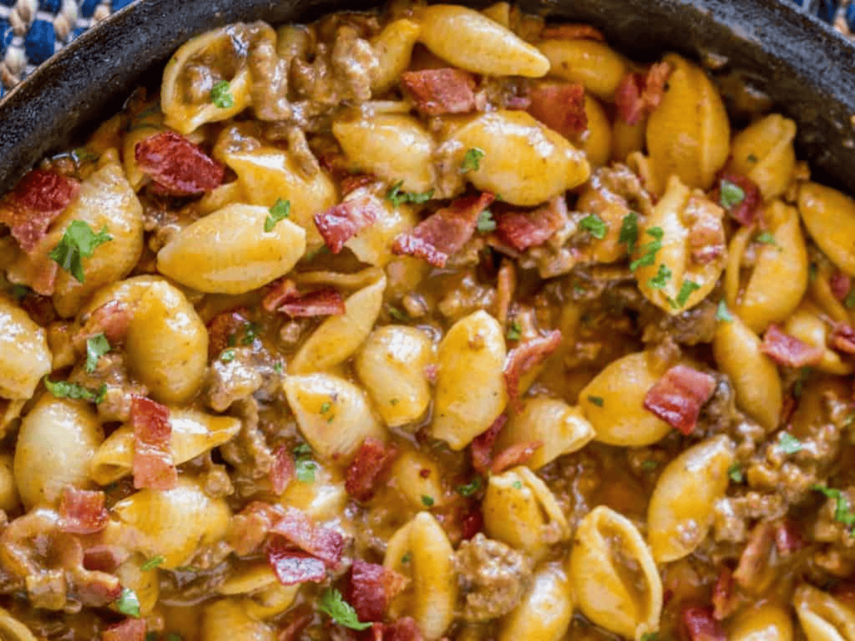 beef and noodle mixture cooking in cast iron