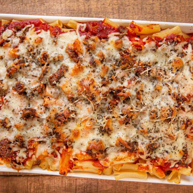 baked pasta with cheese sprinkled on top in a baking sheet