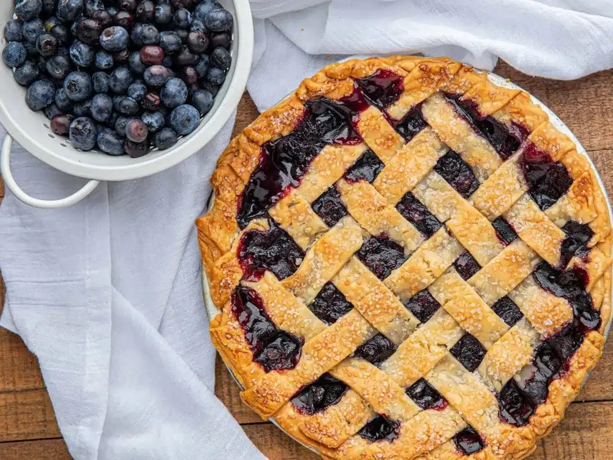 top down view of pie with blueberries on side 