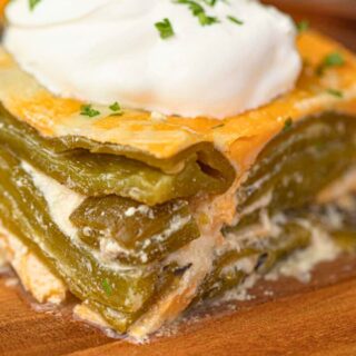 Slice of baked casserole topped with sour cream