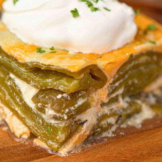 Slice of baked casserole topped with sour cream