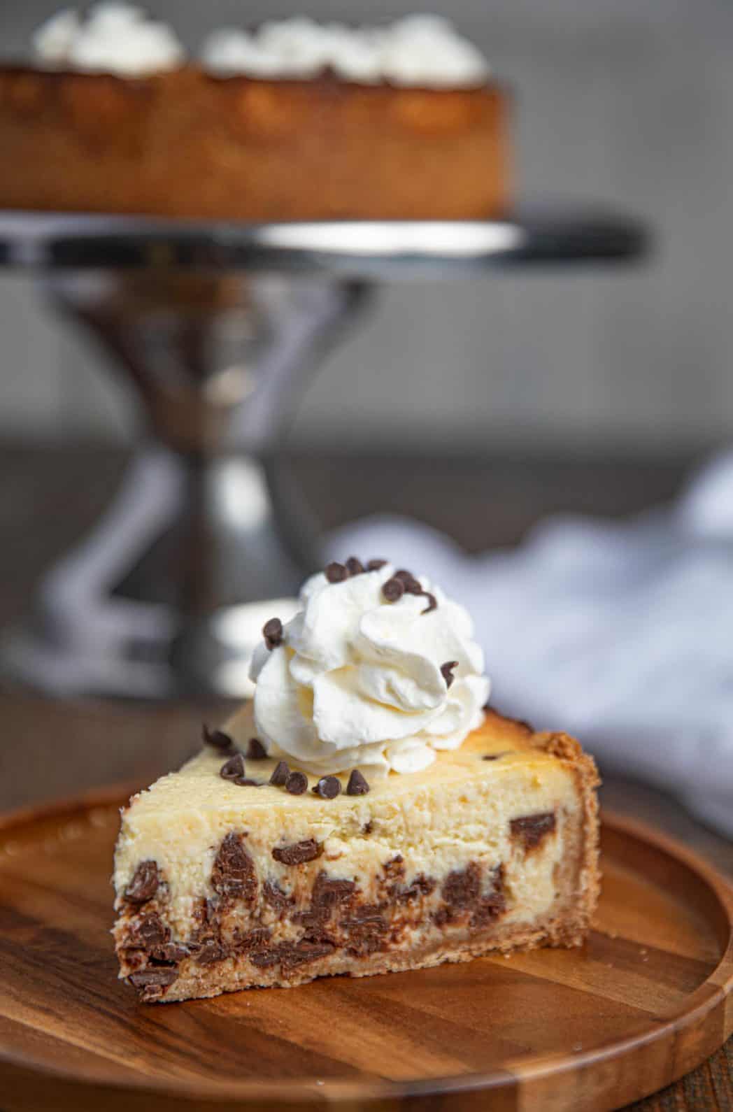 Slice of Chocolate Chip Cheesecake with Whipped Cream on plate