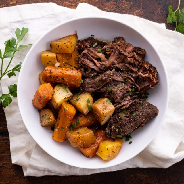 Classic Pot Roast in bowl with carrots and potatoes
