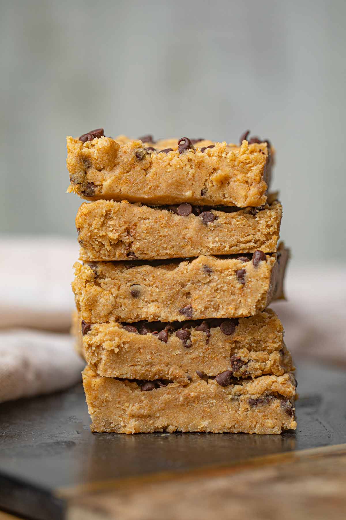 Chocolate Chip Cookie Dough Bars stacked on cutting board