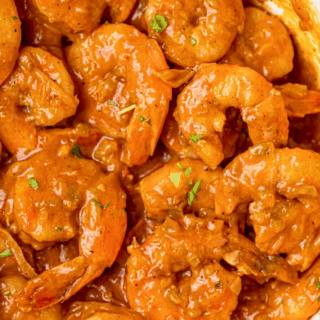 Cooked shrimp in sauce in skillet