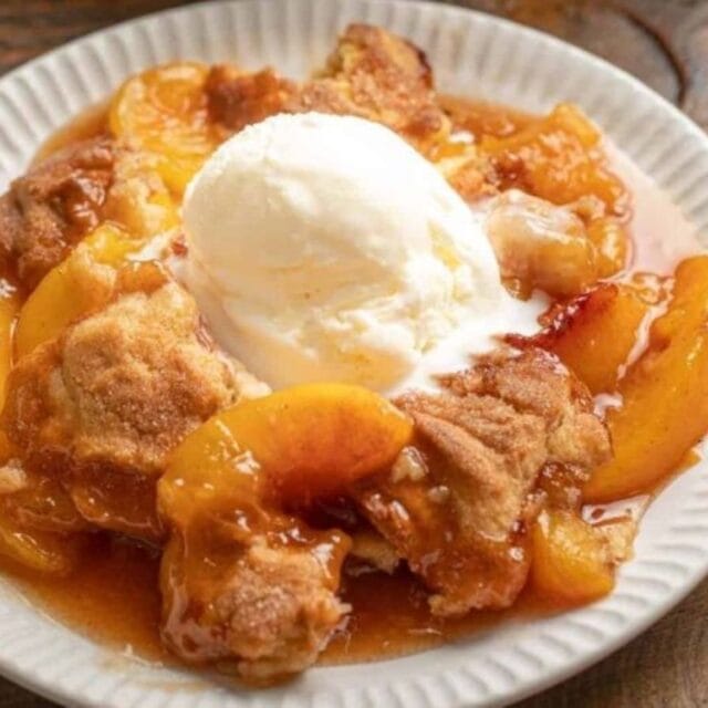 cobbler on a white plate with ice cream.