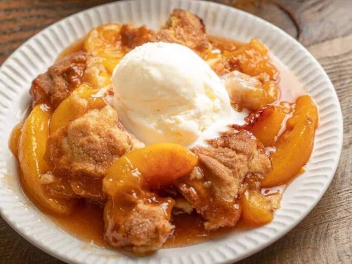 cobbler on a white plate with ice cream.