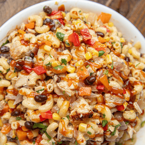 Bowl of pasta salad with BBQ chicken and veggies
