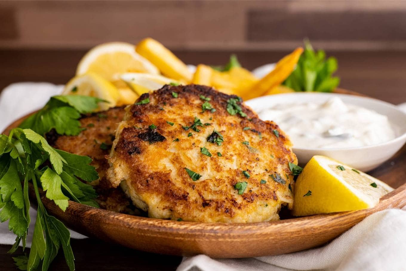 Crab Cakes on plate with lemon wedge