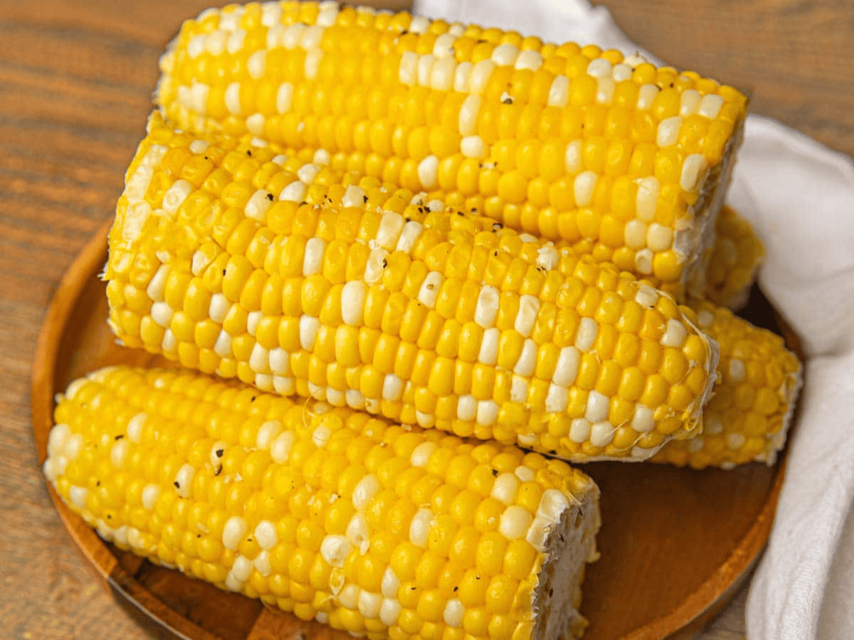 Corn stacked on a wooden platter 