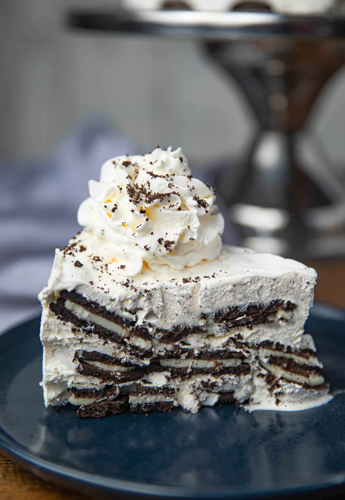 Slice of Oreo Ice Box Cake with Whipped Cream on blue plate