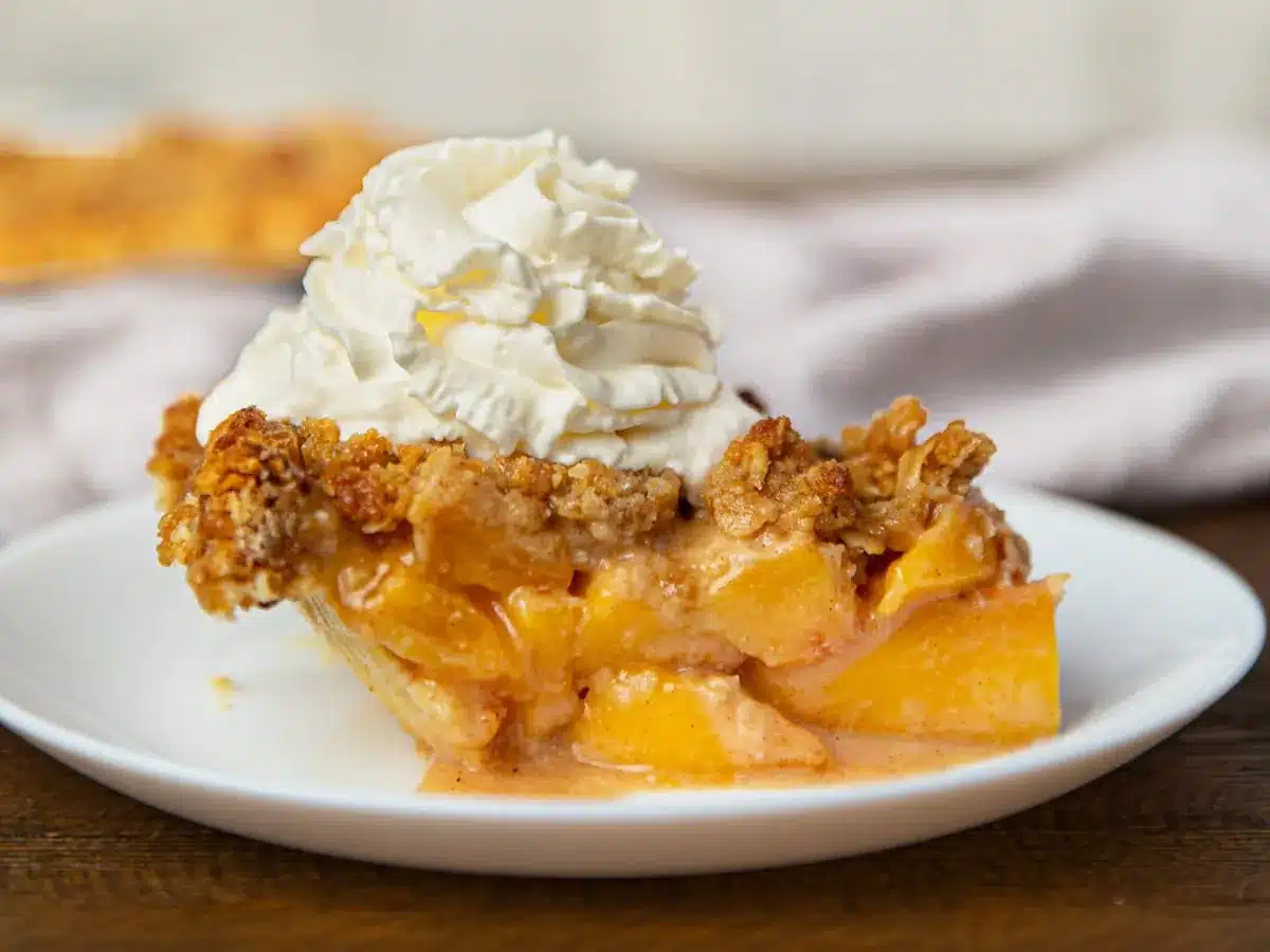 slice of pie on a plate with whip cream on top