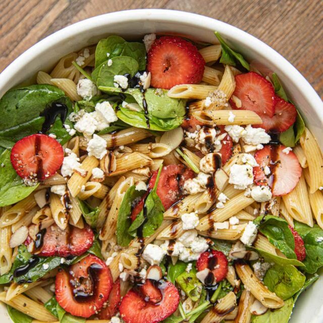 Spinach Pasta Salad with Strawberries in white bowl