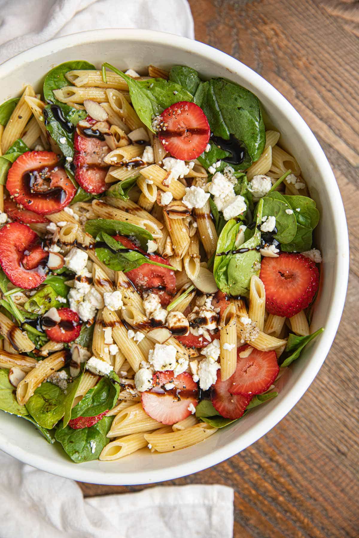 Spinach Pasta Salad with Strawberries in white bowl