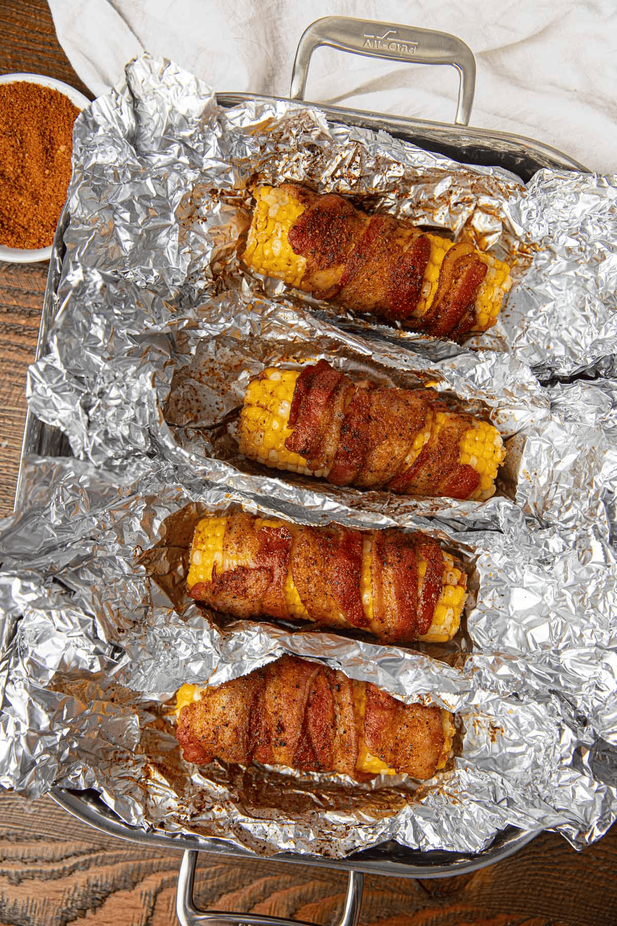 Corn on the cob with bacon on foil