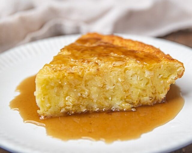 A slice of Coconut Pie with Rum Sauce