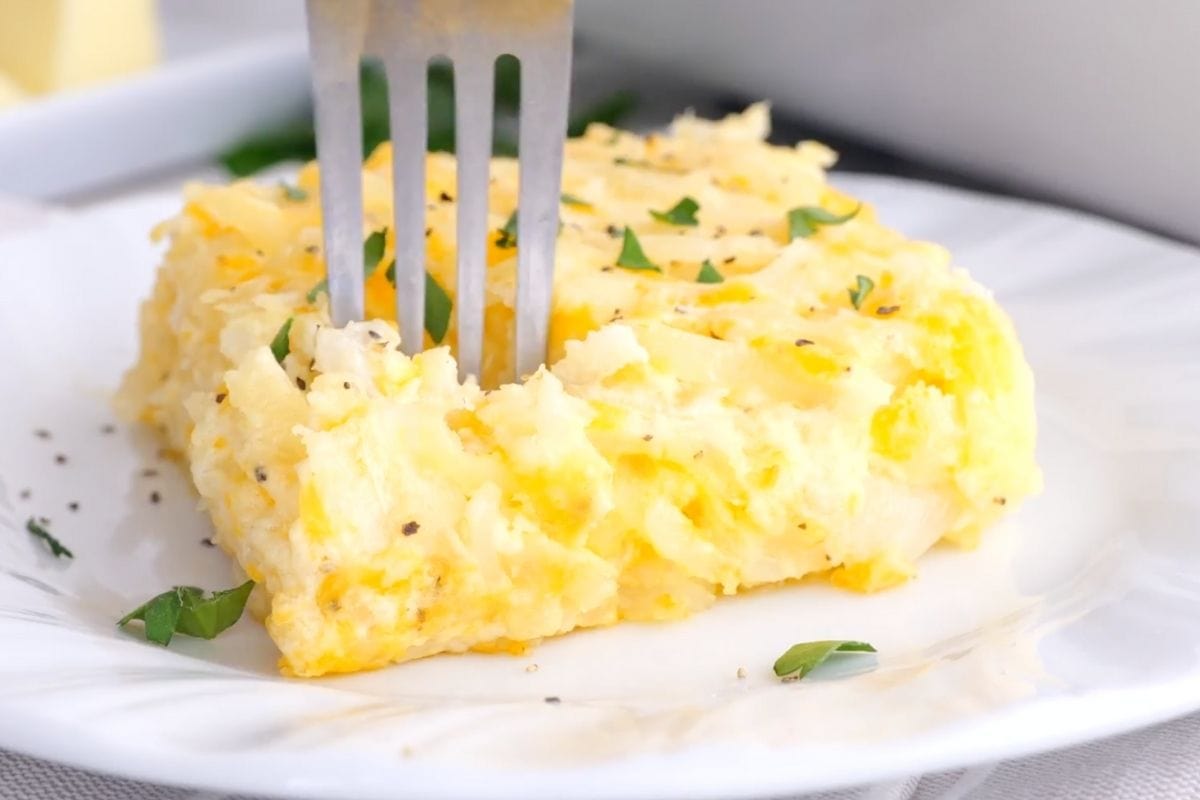 Cracker Barrel Hash Brown Casserole square on plate with fork bite