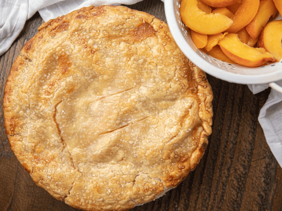 whole pie with fruit in background