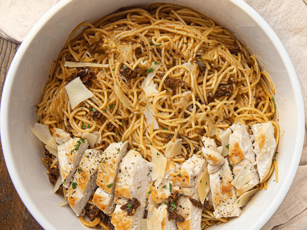 Top view of cooked ingredients and poultry in a serving bowl