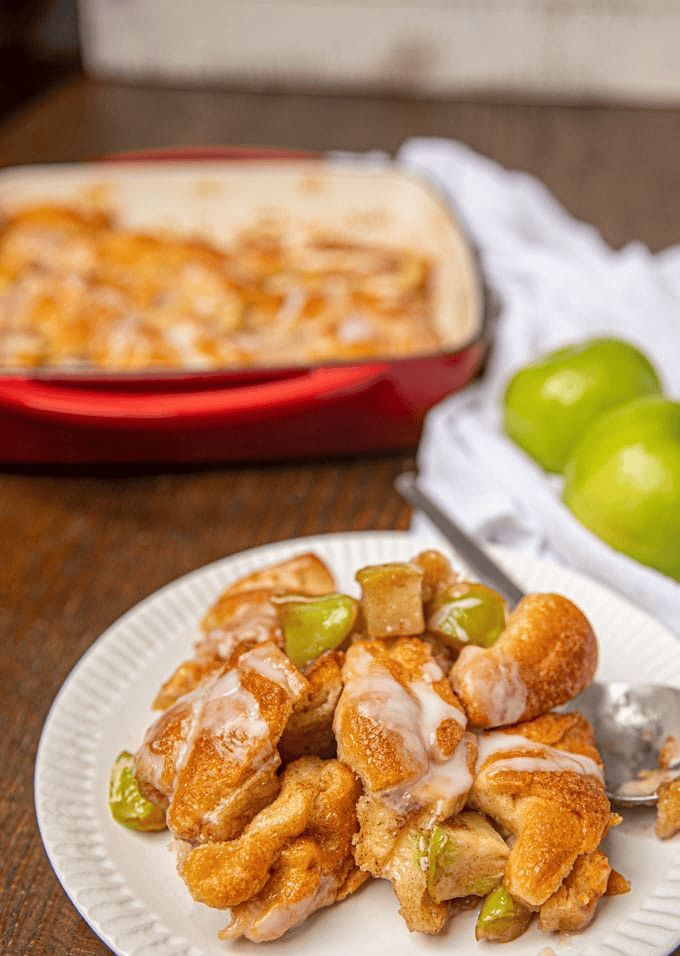 Apple and pastry on a plate with a casserole dish in the background