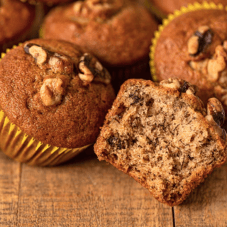 Baked muffins, one in front with bite taken out