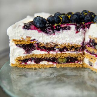Blueberry Lemon Icebox Cake slice on cake dish
