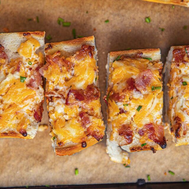 Cheesy Bacon Bread sliced on cutting board