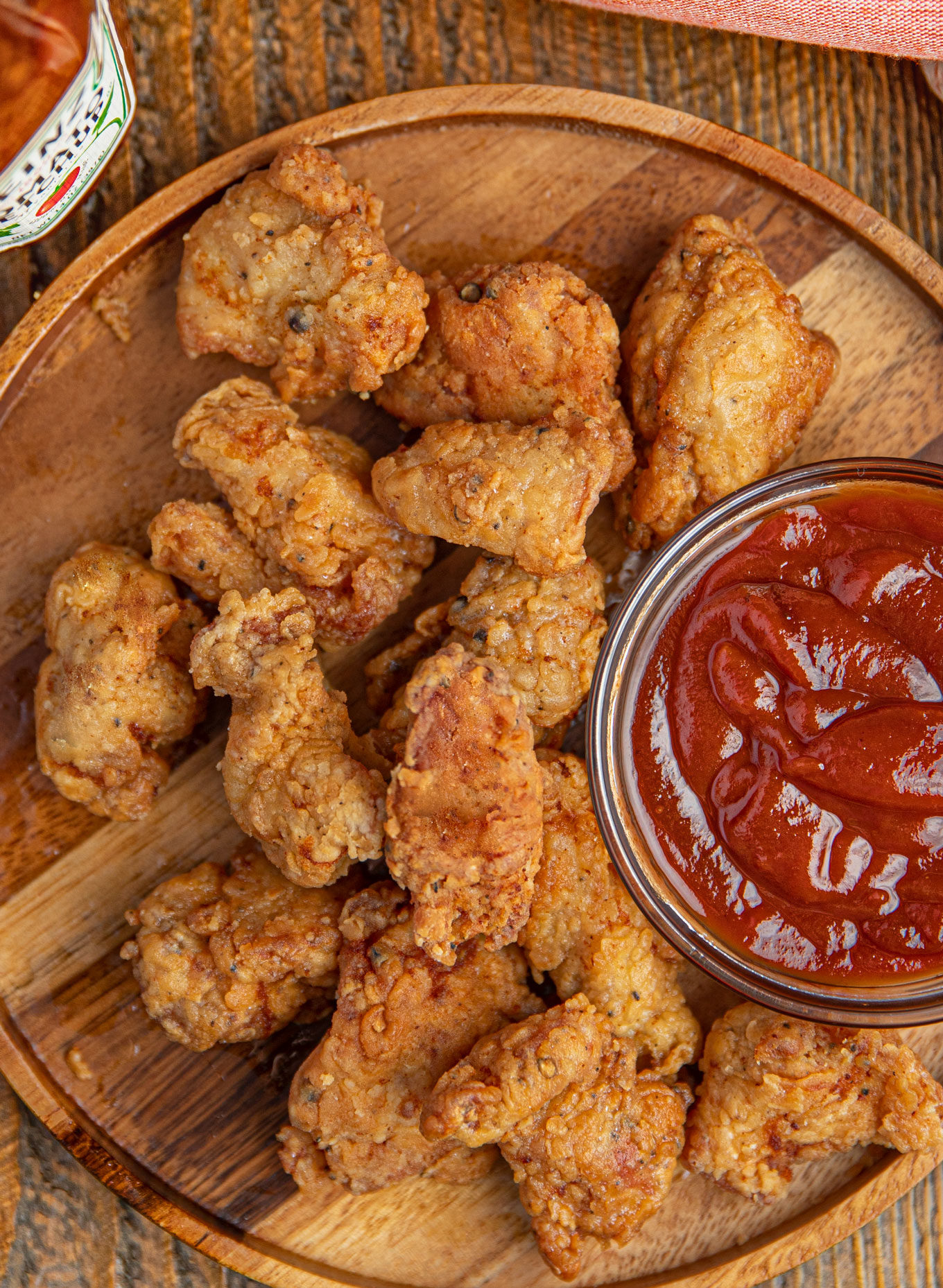 Chicken nuggets on a plate with ketchup