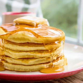 Stack of pancakes with butter and syrup
