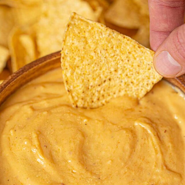 Chip dipping into beer cheese dip