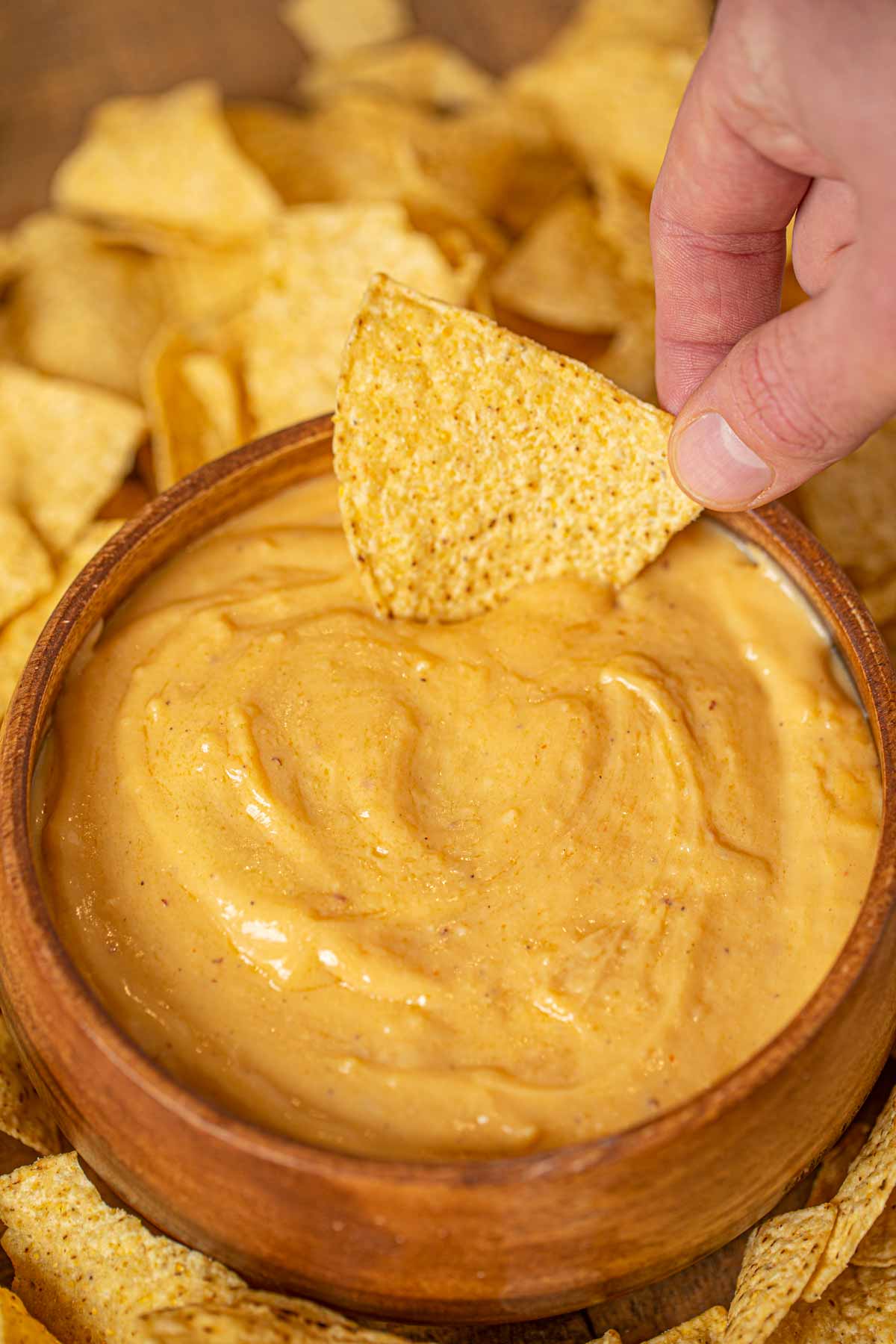 Chip dipping into beer cheese dip