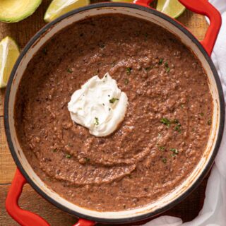 Pot of cooked soup with sour cream dollop