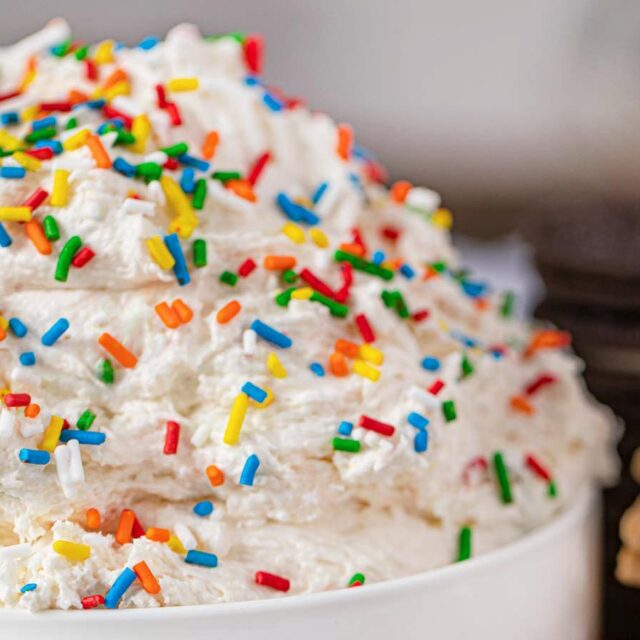 White bowl of dessert dip with rainbow sprinkles