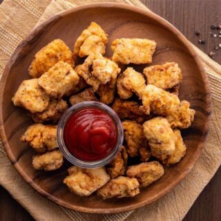 Chicken Nuggets on serving plate with ketchup