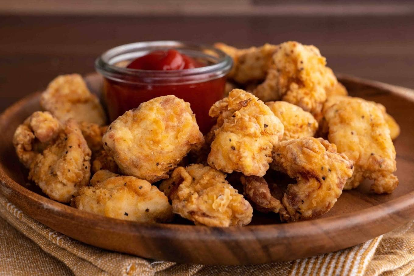 Chicken Nuggets on serving plate with ketchup