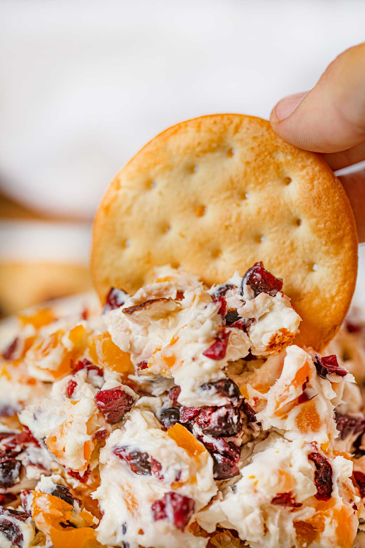 Cracker dipped in Cranberry Cream Cheese Dip