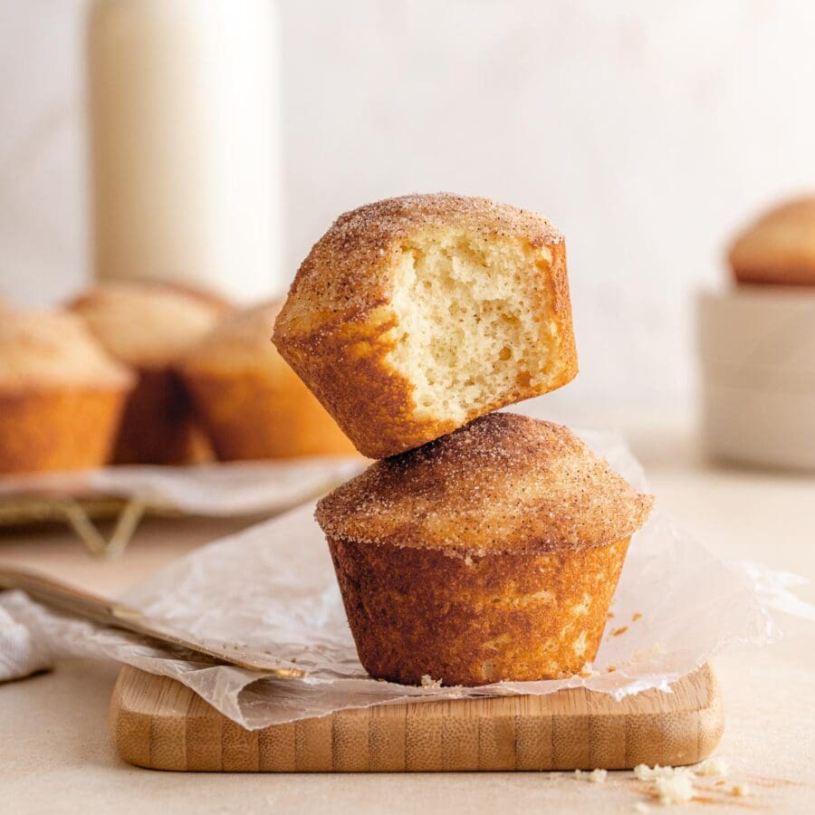 Baked Mini Doughnut Muffins, stacked on a cutting board