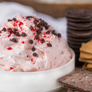 Peppermint Bark Dip topped with mini chocolate chips and peppermint candies