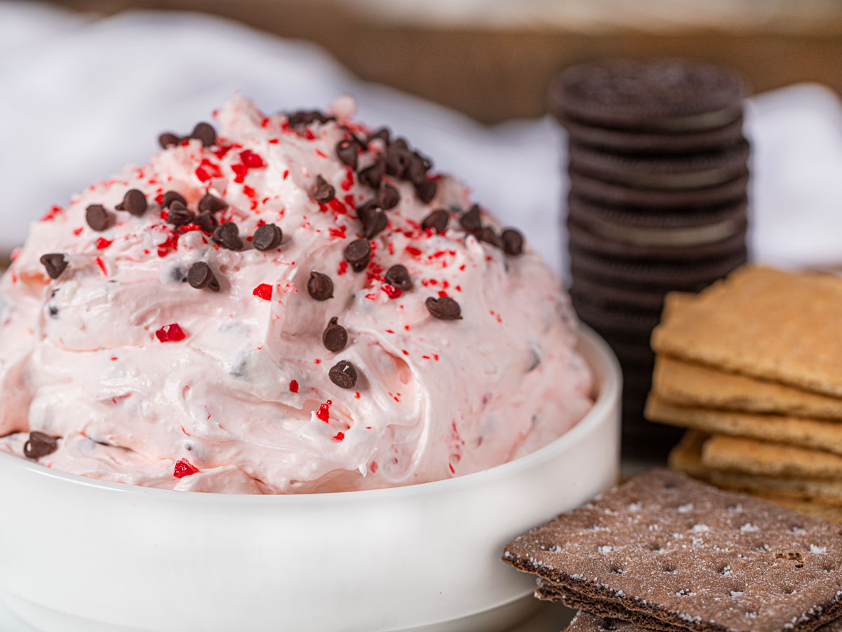 Peppermint Bark Dip topped with mini chocolate chips and peppermint candies